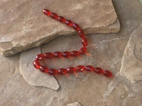 B3960   FULL Strand of Faceted Glass Oval Beads “Red”