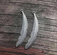 M0281  TWO (2) Silver Plated Feather Pendants