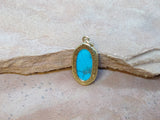 P1561   Howlite Turquoise set in Brass Pendant